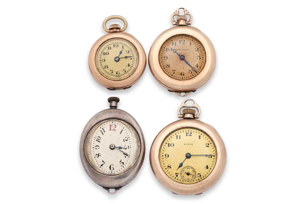 A GROUP OF FOUR PENDANT WATCHES
