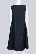COMME DES GARÇONS TRICOT - A SLEEVELESS BLACK PANELLED DRESS WITH RUFFLED TRIM