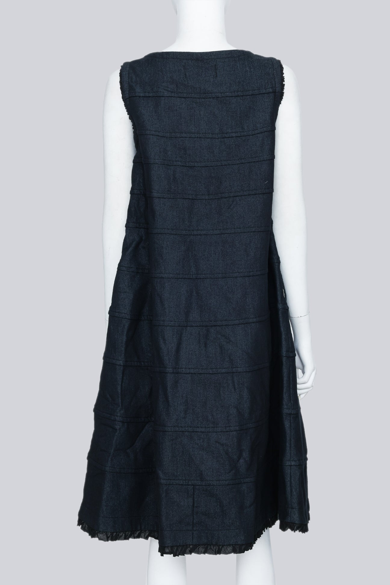 COMME DES GARÇONS TRICOT - A SLEEVELESS BLACK PANELLED DRESS WITH RUFFLED TRIM