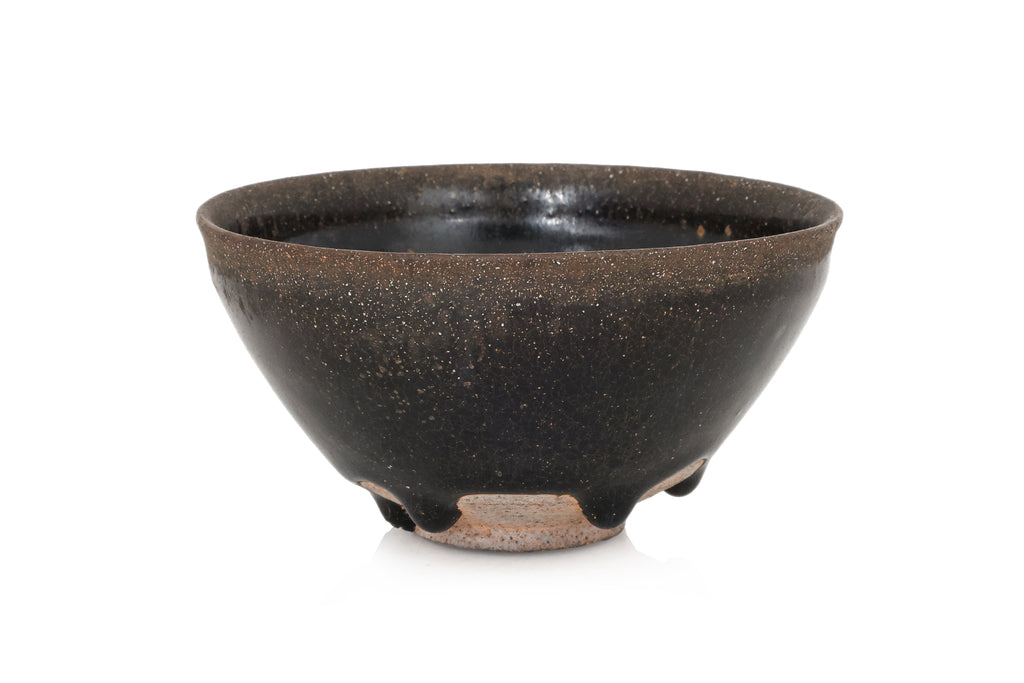 A BLACK GLAZED STONEWARE BOWL