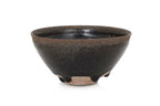 A BLACK GLAZED STONEWARE BOWL