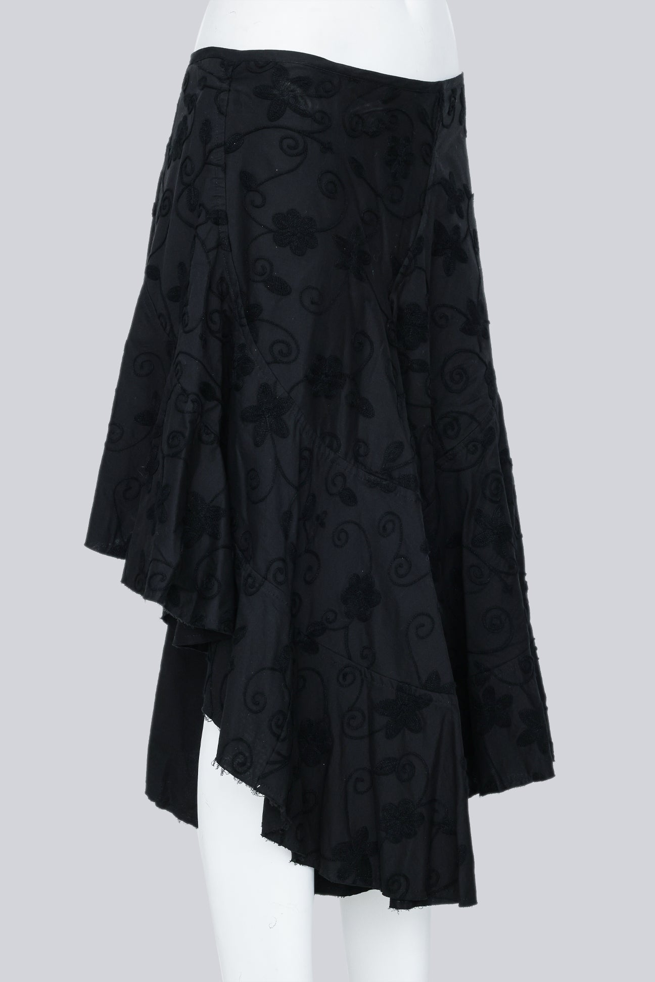 JUNYA WATANABE - A 2002 BLACK EMBROIDERED ASYMMETRICAL WRAP SKIRT WITH A BUCKLE ACCENT