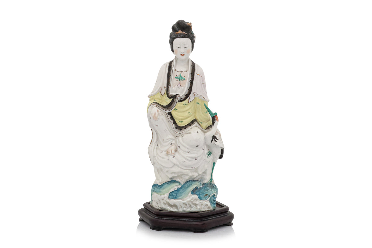 A POLYCHROME-ENAMELLED PORCELAIN FIGURE OF A WOMAN AND BIRD