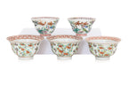 A GROUP OF FIVE FAMILLE ROSE 'MAGPIE' TEA BOWLS