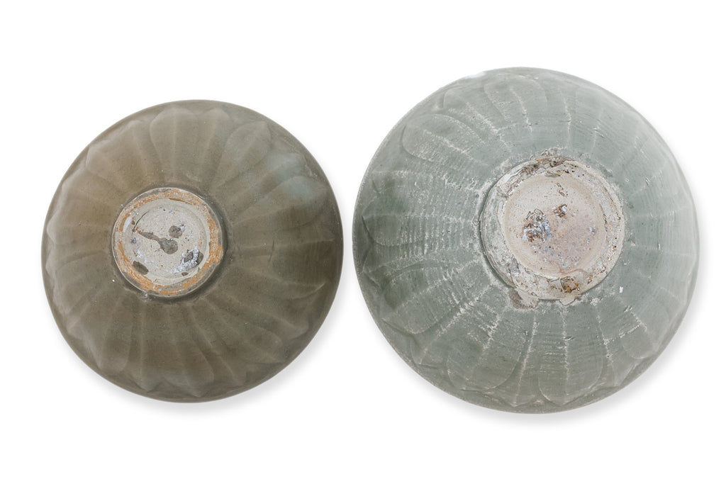 TWO YAOZHOU CELADON GLAZED 'LOTUS' BOWLS